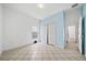 Clean bedroom with tiled floor, white closet doors, and a calming blue accent wall at 4785 Cumbrian Lakes Dr, Kissimmee, FL 34746
