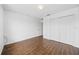 Bright, minimalist bedroom featuring wood-style flooring and ample closet space at 4785 Cumbrian Lakes Dr, Kissimmee, FL 34746