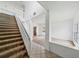 Inviting entryway with high ceilings, tile flooring, carpeted stairs, and an open layout at 4785 Cumbrian Lakes Dr, Kissimmee, FL 34746