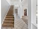 Bright entryway boasts high ceilings, tile flooring, and a carpeted staircase at 4785 Cumbrian Lakes Dr, Kissimmee, FL 34746