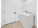 Well-lit laundry area featuring a washer, dryer, and convenient overhead shelving for storage at 4785 Cumbrian Lakes Dr, Kissimmee, FL 34746
