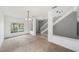 Bright living room with carpet, large window and view of the staircase at 4785 Cumbrian Lakes Dr, Kissimmee, FL 34746