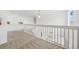 Bright loft with white railings overlooking the lower level, enhancing the home's open feel at 4785 Cumbrian Lakes Dr, Kissimmee, FL 34746
