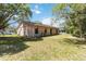Backyard with the home's exterior, showing its windows, sliding glass doors, and well-kept lawn at 4806 Gallant Ln, Orlando, FL 32821