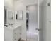 Bright bathroom featuring a white vanity with sink, tiled floor, and doorway to another room at 4806 Gallant Ln, Orlando, FL 32821
