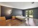 Spacious bedroom with hardwood floors and a sliding glass door for ample lighting at 4806 Gallant Ln, Orlando, FL 32821