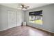 Bedroom with hardwood floors, a window with blinds, closet, and a ceiling fan at 4806 Gallant Ln, Orlando, FL 32821
