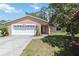 Charming single-story home features an attached two-car garage and well-maintained lawn at 4806 Gallant Ln, Orlando, FL 32821