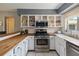 Updated kitchen features stainless steel appliances, butcher block countertops, and white cabinetry at 4806 Gallant Ln, Orlando, FL 32821