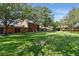 Scenic backyard with a large lawn area and mature trees at 4878 Tangerine Ave # 4878, Winter Park, FL 32792