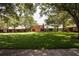 Expansive backyard view featuring lush green grass, mature trees, and well-maintained exterior of homes at 4878 Tangerine Ave # 4878, Winter Park, FL 32792
