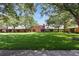 Expansive backyard view showcasing lush green lawn and colorful buildings at 4878 Tangerine Ave # 4878, Winter Park, FL 32792