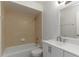 Bathroom featuring tile backsplash, shower over tub, and vanity with modern hardware at 4878 Tangerine Ave # 4878, Winter Park, FL 32792