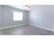 Cozy bedroom featuring laminate flooring and a large window at 4878 Tangerine Ave # 4878, Winter Park, FL 32792