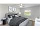 Bedroom featuring a large bed with decorative pillows, side tables with lamps, and a view of the window at 4878 Tangerine Ave # 4878, Winter Park, FL 32792