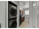 Modern kitchen with stainless appliances, washer/dryer, and wood-look flooring at 4878 Tangerine Ave # 4878, Winter Park, FL 32792