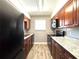 Updated kitchen with dark wood cabinets, granite countertops, and stainless steel appliances at 4878 Tangerine Ave # 4878, Winter Park, FL 32792