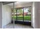 Enclosed lanai with sliding glass doors and view of community greenspace at 4878 Tangerine Ave # 4878, Winter Park, FL 32792