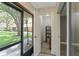 Enclosed lanai with view of the neighborhood and closet with shelving at 4878 Tangerine Ave # 4878, Winter Park, FL 32792