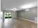 Spacious living room with sliding glass doors, fan, and modern lighting at 4878 Tangerine Ave # 4878, Winter Park, FL 32792