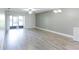 Spacious living room featuring laminate flooring and access to the patio at 4878 Tangerine Ave # 4878, Winter Park, FL 32792