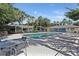 Community pool area with lounge chairs and shade trees at 4878 Tangerine Ave # 4878, Winter Park, FL 32792