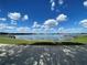 Picturesque water view with a dock, gazebo, and clear blue skies filled with fluffy white clouds at 4878 Tangerine Ave # 4878, Winter Park, FL 32792
