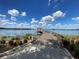 Picturesque water view with a dock, gazebo, and clear blue skies filled with fluffy white clouds at 4878 Tangerine Ave # 4878, Winter Park, FL 32792