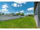 Expansive backyard with a well-maintained lawn and a white fence, offering a serene and private outdoor space at 506 Marion Oaks Trl, Ocala, FL 34473