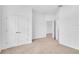 Spacious bedroom with neutral carpet, white walls, and double doors leading to a closet at 506 Marion Oaks Trl, Ocala, FL 34473
