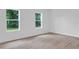 Bright bedroom with laminate flooring and two windows at 506 Marion Oaks Trl, Ocala, FL 34473