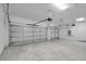 Spacious three-car garage with white doors and ample concrete flooring at 506 Marion Oaks Trl, Ocala, FL 34473