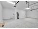 Clean and spacious three-car garage interior showing ample storage with a water heater at 506 Marion Oaks Trl, Ocala, FL 34473