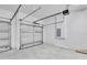 Three-car garage featuring ample parking space, white walls, and overhead door mechanics at 506 Marion Oaks Trl, Ocala, FL 34473
