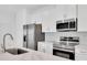 Close up on the kitchen with stainless steel appliances and marbled countertops at 506 Marion Oaks Trl, Ocala, FL 34473