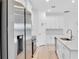 White kitchen with stainless steel refrigerator and quartz countertops at 506 Marion Oaks Trl, Ocala, FL 34473