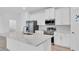 Kitchen with stainless steel refrigerator and oven, along with bright white cabinets at 506 Marion Oaks Trl, Ocala, FL 34473