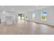 Bright, open-concept living room featuring hardwood floors, recessed lighting, and sliding glass doors to the patio at 506 Marion Oaks Trl, Ocala, FL 34473