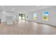 Bright, open-concept living area with white walls and luxury vinyl flooring at 506 Marion Oaks Trl, Ocala, FL 34473