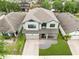 Aerial view of the property showing its well-maintained roof, landscaping, and proximity to neighboring homes at 5116 Sorrento W Blvd, St Cloud, FL 34771