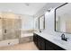 Bright bathroom with a double sink vanity, soaking tub and a glass-enclosed shower at 5116 Sorrento W Blvd, St Cloud, FL 34771