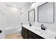 Elegant bathroom with dual sinks, modern fixtures, and a tiled shower-tub combination at 5116 Sorrento W Blvd, St Cloud, FL 34771