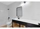 Bright bathroom features white tile shower over tub, sleek black fixtures, and modern vanity with solid surface counter at 5116 Sorrento W Blvd, St Cloud, FL 34771