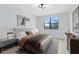 Stylishly staged bedroom featuring modern decor, large window, and neutral color palette at 5116 Sorrento W Blvd, St Cloud, FL 34771