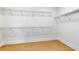Walk-in closet with white walls, light wood floors, and wire shelving at 5116 Sorrento W Blvd, St Cloud, FL 34771