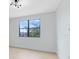 Bright and empty room with hardwood floors and a large window that provides ample natural light at 5116 Sorrento W Blvd, St Cloud, FL 34771
