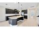 Modern kitchen with a large kitchen island, granite counters and stainless appliances at 5116 Sorrento W Blvd, St Cloud, FL 34771