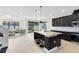 Open kitchen with dark cabinets, stainless steel appliances, granite countertops, and a breakfast bar at 5116 Sorrento W Blvd, St Cloud, FL 34771