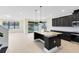 Open kitchen with dark cabinets, stainless steel appliances, granite countertops, and a breakfast bar at 5116 Sorrento W Blvd, St Cloud, FL 34771