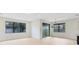 Bright living room with ample natural light and modern chandelier, flowing into dining area at 5116 Sorrento W Blvd, St Cloud, FL 34771